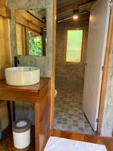 a bathroom with a sink and a toilet and a mirror at Koh Mook Banana Garden in Ko Libong