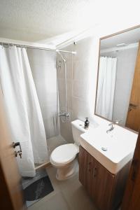 a bathroom with a toilet and a sink and a mirror at Sands Guesthouse Apartment 03 In Batroun in Batroûn