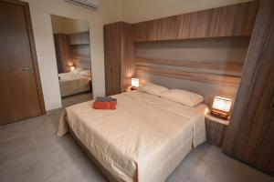 a bedroom with a large white bed with two lamps at Sands Guesthouse Apartment 03 In Batroun in Batroûn