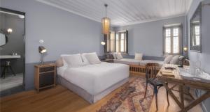 a bedroom with a white bed and a couch at Apeiros Chora Hotel in Kato Pedina +52 photos