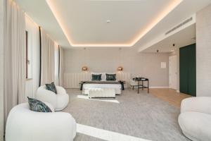 a hotel room with a bed and two chairs at Haven Nature Hotel & Villas in Batalha