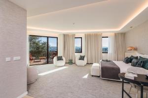 a hotel room with a bed and a table and chairs at Haven Nature Hotel & Villas in Batalha