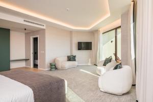 a hotel room with a bed and two chairs at Haven Nature Hotel & Villas in Batalha