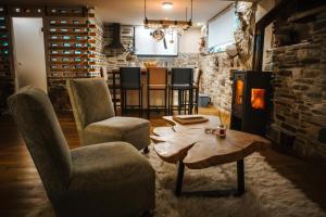 a living room with a table and chairs and a fireplace at Handmade semi basement in Ioannina