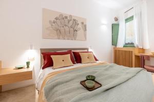 a bedroom with a bed with a tray on it at Vico Trigona SicilyMyHome e jacuzzi riscaldata in Noto +45 photos