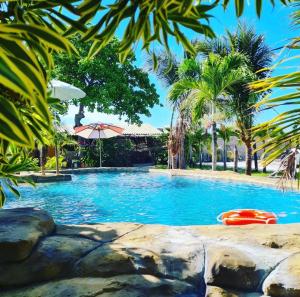 a swimming pool with a red raft in the middle at Chalé Brisa do Pontal in Fortim