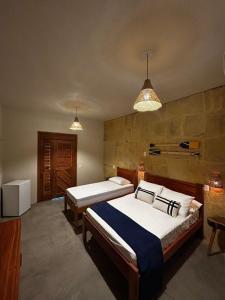 Una cama o camas en una habitación de Chalé Brisa do Pontal