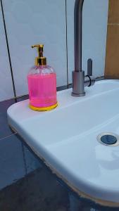 a pink bottle sitting on top of a surfboard at Tigris Residence in Bulenga