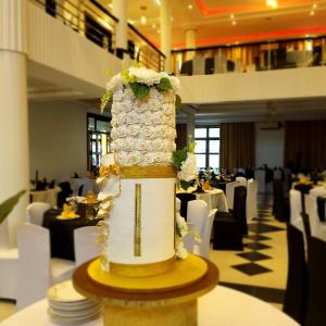 a wedding cake sitting on top of a table in a restaurant at Tigris Residence in Bulenga
