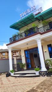 a building with a balcony on top of it at Tigris Residence in Bulenga