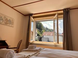 a bedroom with a large window with a view at City Center Apartment 1 in Interlaken