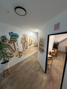 a hallway with a wall with a mural of animals at Suite 2- La Petite Auberge in Langres