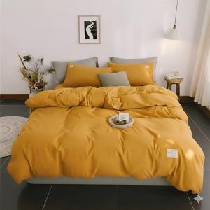 a bed with a yellow comforter on it at Pin's House in Bao Loc +37 photos