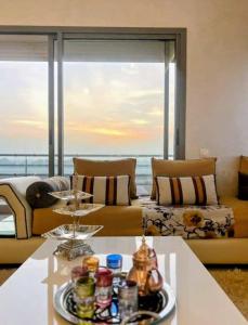 a living room with a couch and a table at 3BR Near Airport Secure,Equipped stay and transit in Nouaseur