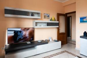a living room with a large flat screen tv at La Playa di Ponente in Cagliari +61 photos