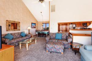 a living room with couches and a table at AC1H - Seawind in Nags Head