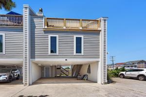 a large house with a deck on top of it at AC1H - Seawind in Nags Head
