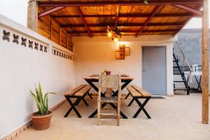 a dining room with a wooden table and chairs at Surf Away Morocco in Agadir