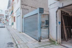 a metal garage door on the side of a building at Handmade semi basement in Ioannina