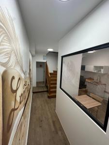 a room with a wall with a sign on it at Suite 3- La Petite Auberge in Langres +2 photos