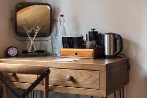 a wooden dresser with a mirror on top of it at The Three Swallows Cley in Cley next the Sea