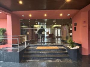 a lobby with stairs in front of a building at Hotel Carqueijais - Serra da Estrela in Covilhã +53 photos