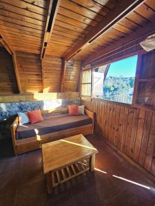 a room with a bed and a table in a cabin at Village in La Cumbrecita +12 photos