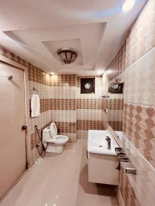 a bathroom with a toilet and a sink at Relax Lodge Family Guest House in Islamabad