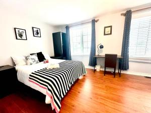 um quarto com uma cama e uma escrivaninha em Cozy Queen room with Shared Bath near Seneca Finch 404 em Toronto