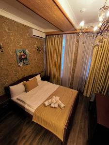 a bedroom with a bed with two towels on it at Antique Royal Hotel in Baku +49 photos