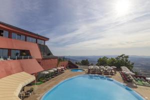 a view of a hotel with a swimming pool at Hotel Carqueijais - Serra da Estrela in Covilhã