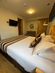 Ένα ή περισσότερα κρεβάτια σε δωμάτιο στο CASA CRISTOBAL Centenario