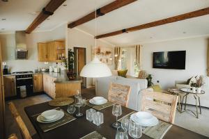 a kitchen and a living room with a dining table at Caer Rhun Hall Hotel in Conwy
