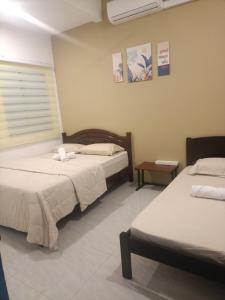 En eller flere senge i et værelse på Ipoh budget house