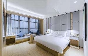Ένα ή περισσότερα κρεβάτια σε δωμάτιο στο JI Hotel Shanghai Caohejing Hongmei Road