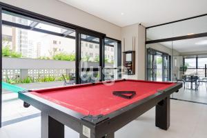 a pool table in the middle of a room at Studio Resort Heated Pool GYM Best Location in Curitiba