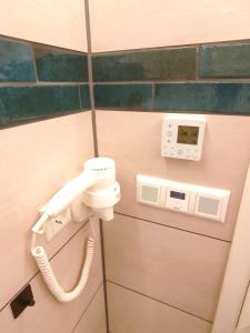 a phone in a bathroom with a phone at Komfortabler Bungalow Am Schlosswald mit privater Sauna&Terrasse - Wernigerode Harz in Wernigerode +10 photos