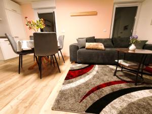 a living room with a couch and a table at Bungalow Am Schlosswald-Infrarotsauna, Klimaanlage&Terrasse - Wernigerode Harz in Wernigerode