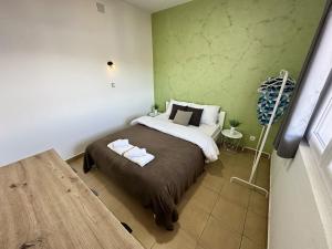 a bedroom with a bed in a room with green walls at Apartmani Zaliv in Tivat