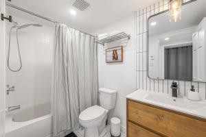 a bathroom with a toilet and a sink and a shower at Hameau 26-43 Studio in Stoneham