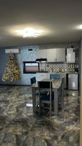 a kitchen with a table and a christmas tree at Shahdag Berghoff House in Qusar