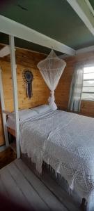 a bedroom with a white bed with a white canopy at Casa Iris del monte in La Pedrera