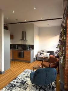 a living room with a couch and a table at Stylish City Loft Getaway in Nottingham