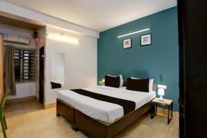 Postel nebo postele na pokoji v ubytování Collection O KIIT Square Bhubaneswar Formerly Nilay Classic