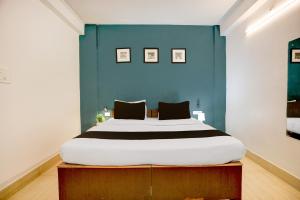 Postel nebo postele na pokoji v ubytování Collection O KIIT Square Bhubaneswar Formerly Nilay Classic