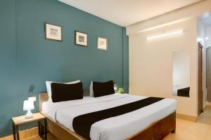 Postel nebo postele na pokoji v ubytování Collection O KIIT Square Bhubaneswar Formerly Nilay Classic