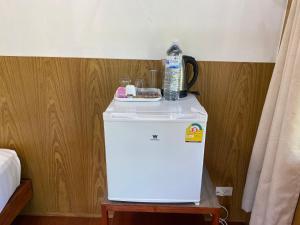 a bottle of water sitting on top of a refrigerator at Mook Happy Bungalow in Koh Mook