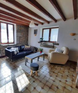 a living room with a couch and a table and chairs at Maison au calme en Chartreuse in Miribel-les-Échelles