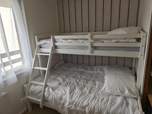 two bunk beds in a room with a bed at Appartement Peyragudes les Agudes in Gouaux-de-Larboust +4 photos
