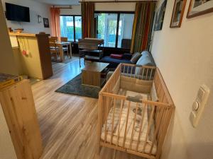 a living room with a crib in a living room at Ferienwohnung Sunnabichi in Wertach